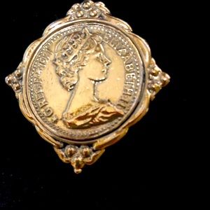 Brooch medallion style in a gold metal that never tarnish it is almost 2”x2